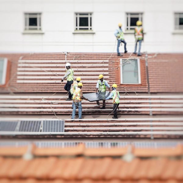 Workers installing solar panels