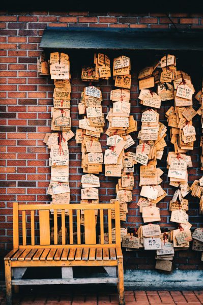 Notes with words on a brick wall