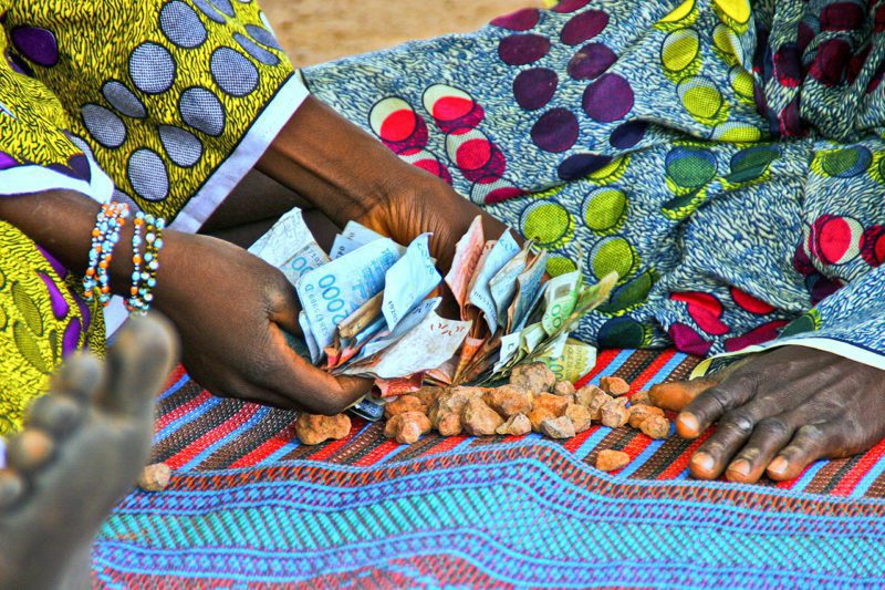 African hands with currency