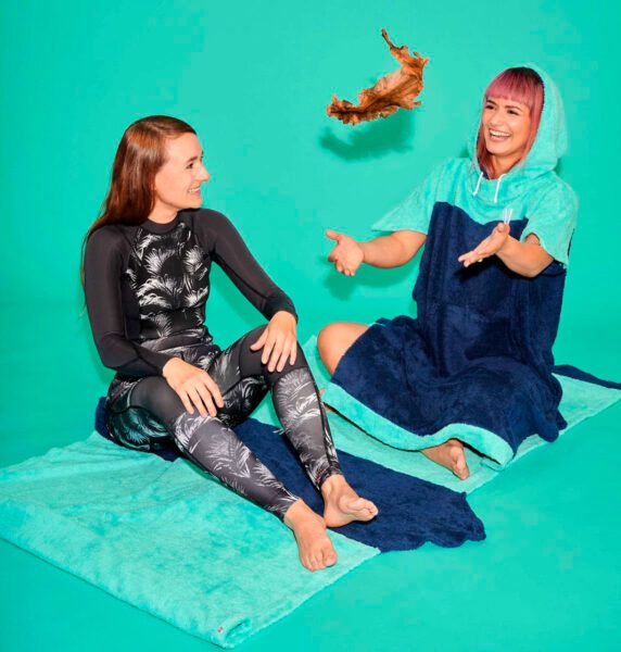 Two women from Vyld seated on green mat
