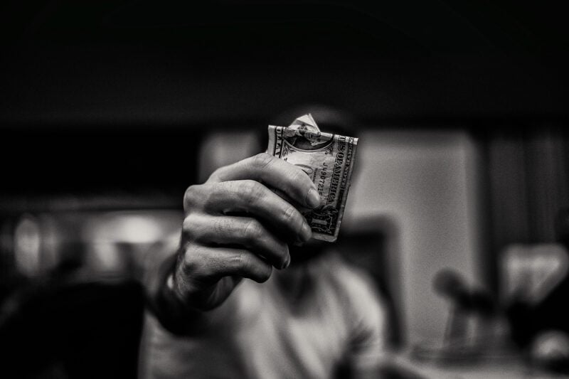 Hand holding dollar bill